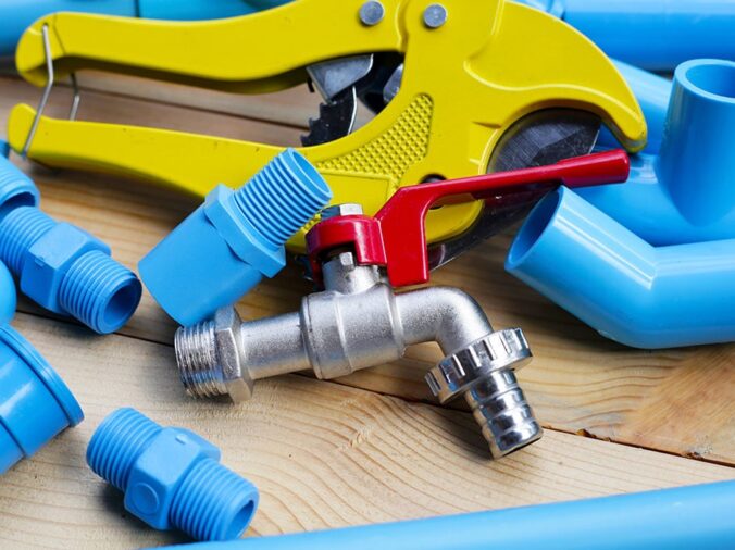 Blue PVC pipes and fittins, PVC cutting tool and steel valve