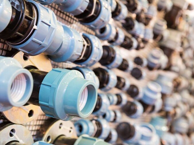 Blue PVC plumbing unions and fittings in a plumbing store