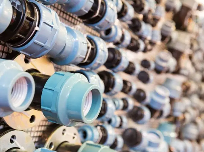 Blue PVC plumbing unions and fittings in a plumbing store